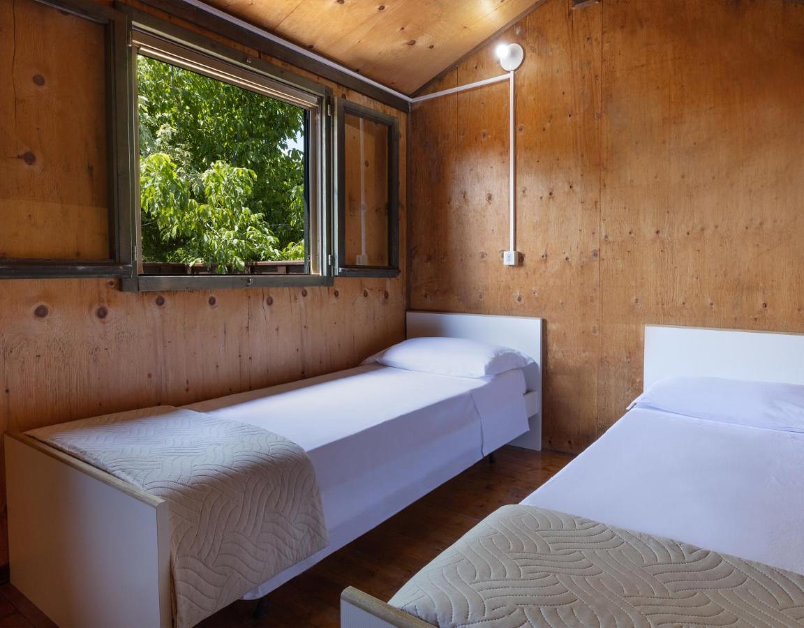 Bungalow - Lake (Pool View) - Ground floor with air conditioning, one double room and one open space with bunk bed. First floor one twin room, no air conditioning - NO PETS ALLOWED
